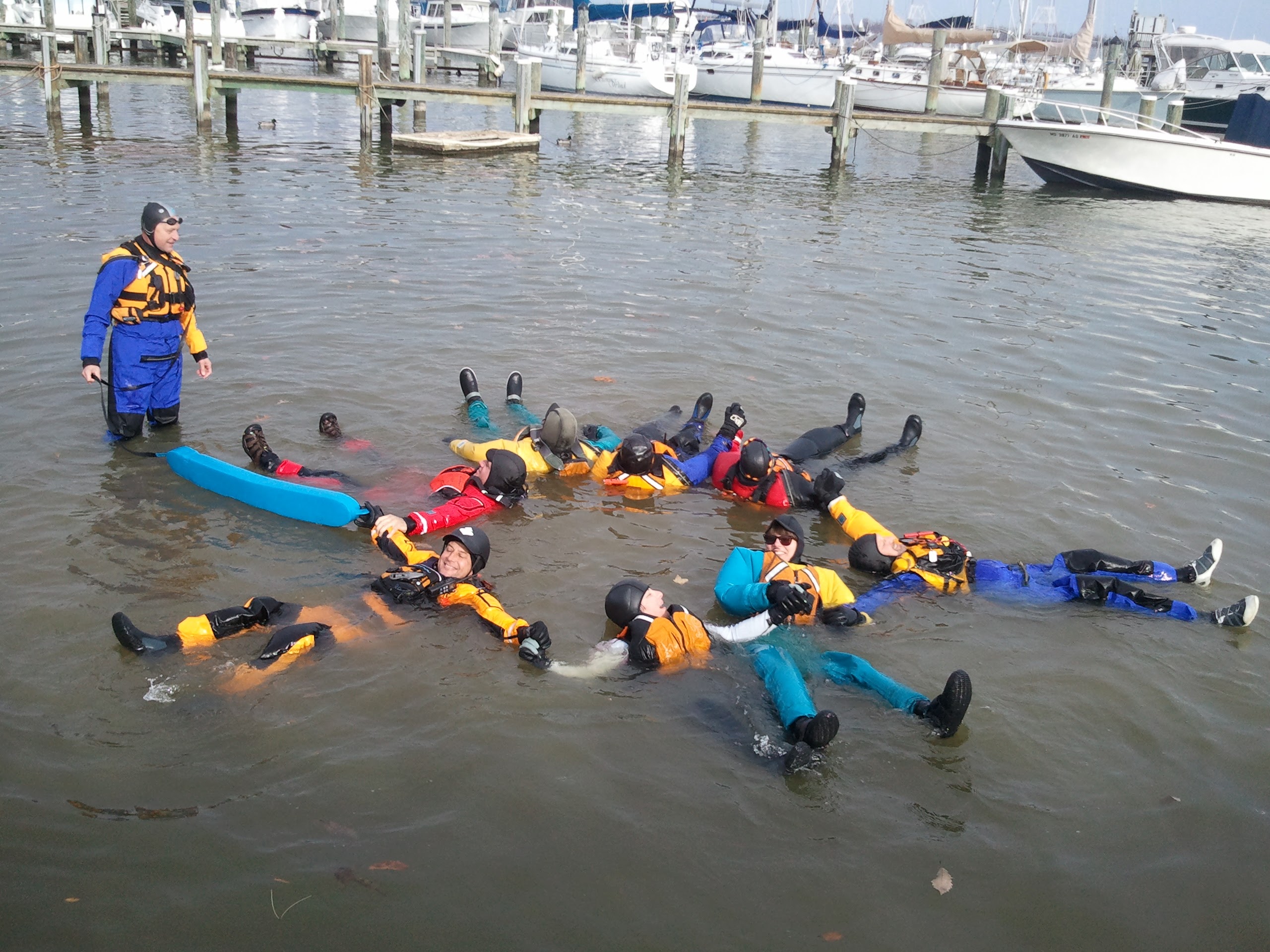 Paddlers swim testing drysuits and cold water gear